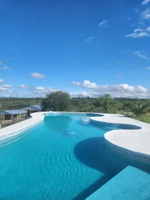 an infinity pool with blue water in a resort at Balcones del Cristal - Picaflor in Tanti
