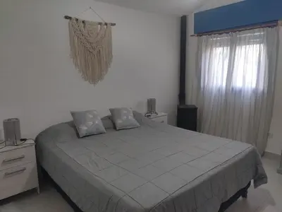 a bedroom with a large bed and a window at La Calma in Los Reartes