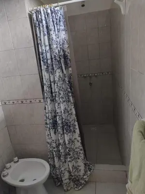a bathroom with a shower with a toilet and a sink at La Calma in Los Reartes