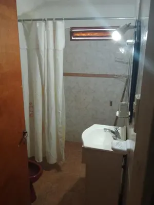 a bathroom with a shower curtain and a sink at casa en bialet masse in San Roque