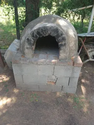 an outdoor brick oven sitting in a field at casa en bialet masse in San Roque