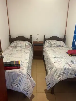 two beds sitting next to each other in a room at Cocoalojamiento in Cavalango