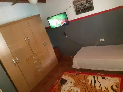 a bedroom with a bed and a flat screen tv at casa para 12 personas en bialet in San Roque