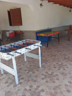 a ping pong table in a room with two tables at casa para 12 personas en bialet in San Roque
