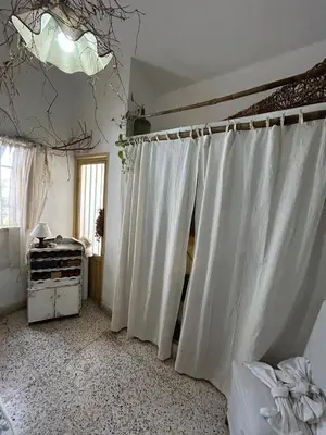 a room with white curtains and a window at Casa Jaz in Villa Carlos Paz