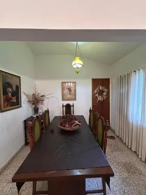a dining room table and chairs in a room at Casa Jaz in Villa Carlos Paz