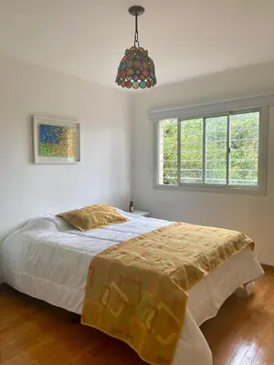 a bedroom with a bed and a large window at Departamento Nuñez in Cordoba