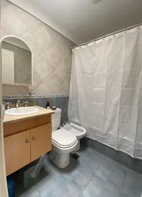 a bathroom with a toilet and a sink and a mirror at Departamento Nuñez in Cordoba