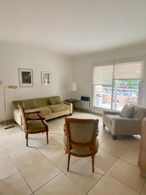 a living room with a couch and a table and chairs at Departamento Nuñez in Cordoba