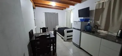 a kitchen with a counter and a table and a kitchen with a tableablish at Apartamento Jhaky 2 in Villa Carlos Paz