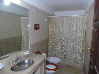 a bathroom with a sink and a toilet and a shower at Casa en Cabalango para 10 personas in Cavalango