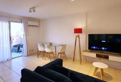 a living room with a couch and a tv and a table at Moderno PENTHOUSE en Nueva in Cordoba