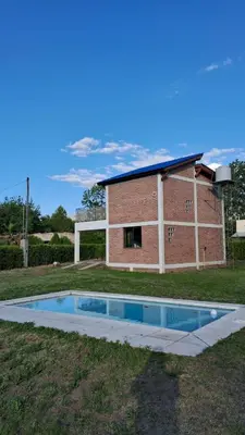 a house with a swimming pool in the yard at Lo de la Abu in Villa de Las Rosas