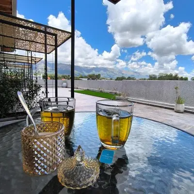 two glasses of wine on a table next to a pool at Moderno Departamento para parejas Merlo S Luis centro Vistas in Merlo