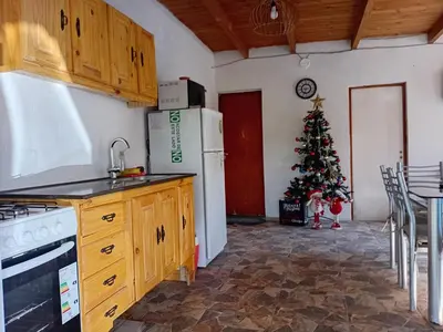 a kitchen with a christmas tree in the corner at La Gringa in Villa Parque Siquiman