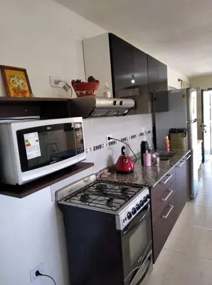 a kitchen with a stove and a microwave at casa lomas in San Antonio de Arredondo