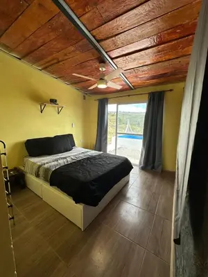 a bedroom with a bed and a wooden ceiling at Ecolodge in Potrero de Garay