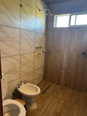 a bathroom with a toilet and a sink and a shower at Ecolodge in Potrero de Garay