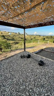 a table with a roof on top of a road at Ecolodge in Potrero de Garay