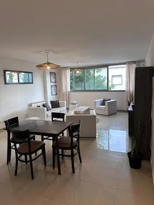 a large living room with a table and chairs at Depto centro in Villa Carlos Paz
