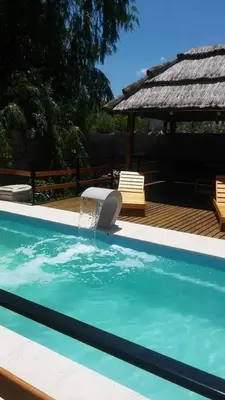 a swimming pool with a fountain in the middle at mi casita en tanti, casa 25 in Tanti