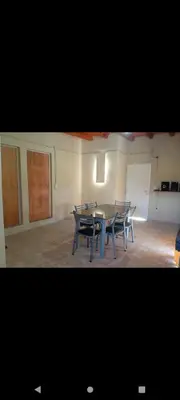 a dining room with a table and chairs in a room at El Crespín in San Lorenzo