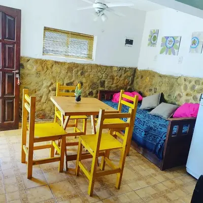 a dining room with a table and chairs and a bed at Abuela Angélica in San Lorenzo