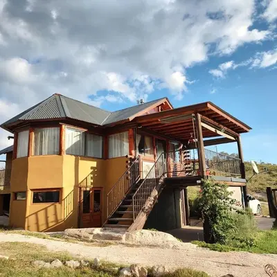 a large house with a staircase in front of it at Cabañas El Mirador in Calmayo