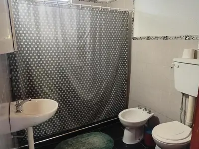 a bathroom with a shower and a toilet and a sink at La grina in Bialet Massé