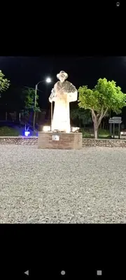 a statue in a park at night with a street light at Crespito in San Lorenzo