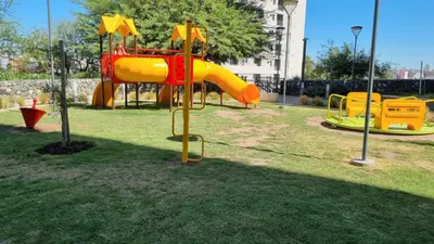 a playground with a slide in a park at Departamento a Pasos de la Terminal y Hospitales in Cordoba