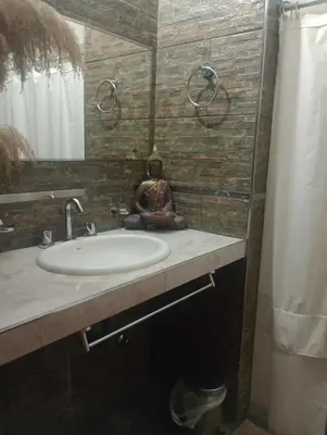 a bathroom with a sink and a mirror and a shower at Casa Francesca in Villa Carlos Paz