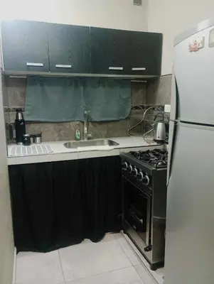 a kitchen with a stove and a refrigerator at Casa Francesca in Villa Carlos Paz