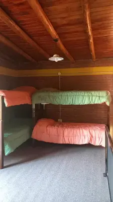two bunk beds in a room with wooden ceilings at Los algarrobos in Mina Clavero