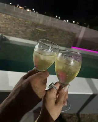 two people are holding up glasses of wine at Casa con pileta privada para 5 in Villa Carlos Paz