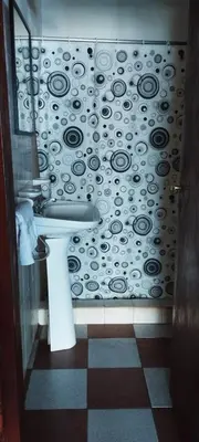 a bathroom with a sink and a black and white wall at Habitación con baño privado en el corazón de Nono in Nono