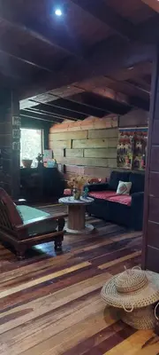 a living room with a couch and a table at Tierra de Sueños in Santa Rosa de Calamuchita