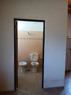 a bathroom with a toilet and a bidet at La Soñada in Villa Independencia