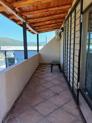 a balcony with a bench on the side of a building at La Soñada in Villa Independencia