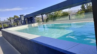 a large swimming pool on top of a building at Dpto Premium Costanera cochera y patio privado in Villa Carlos Paz