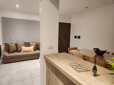 a kitchen and living room with a couch in the background at Departamento macrocentro I, espacioso Río Cuarto in Río Cuarto