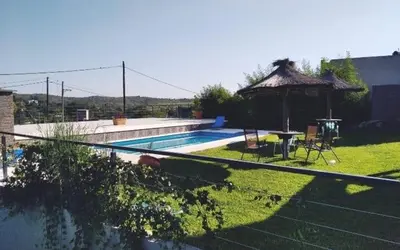 a swimming pool with a gazebo in a yard at paraíso lomas in San Antonio de Arredondo
