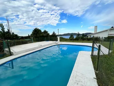 a swimming pool with blue water in a yard at Mar y Mar Naturaleza y comodidad in La Estancia