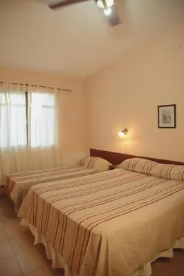 two beds in a bedroom with a window at Departamento espiral in Embalse