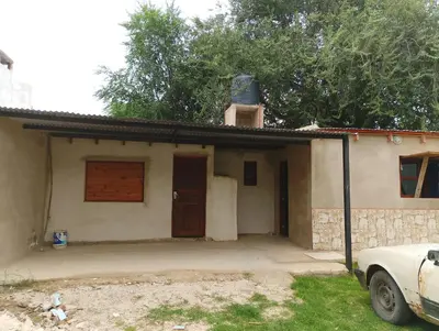a house with a car parked in front of it at La Emi in Bialet Massé