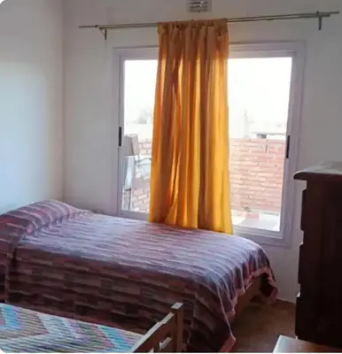 a bedroom with a bed in front of a window at Depto amoblado in Río Tercero