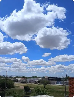 a blue sky with white clouds in a parking lot at Depto amoblado in Río Tercero
