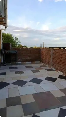 a patio with a brick wall and a tile floor at Depto amoblado in Río Tercero