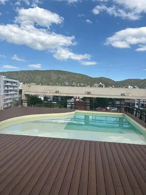 a swimming pool on the roof of a building at Amelia 2-1 in Villa Carlos Paz