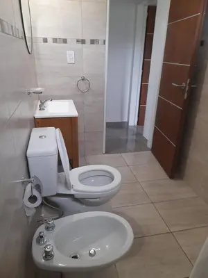 a bathroom with a toilet and a sink at Casa los nonos in Cordoba